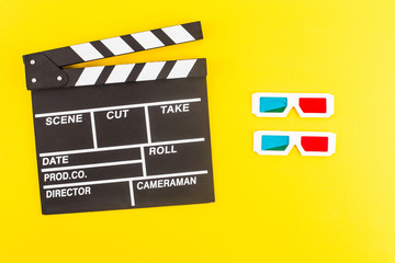 Naklejka premium top view of black clapperboard and 3d glasses isolated on yellow