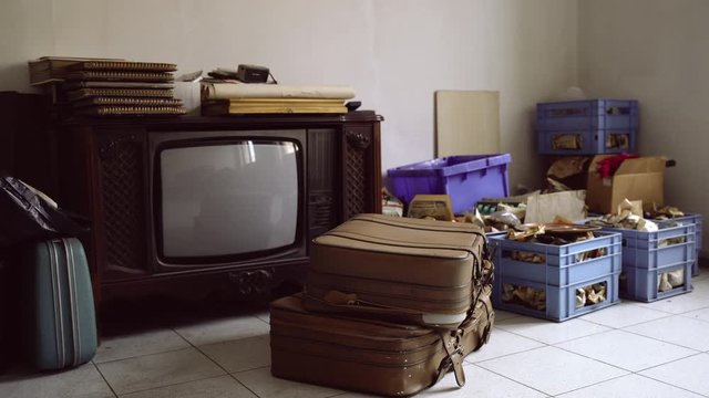 Abandoned old room with pile of used things and furniture. Abandoned apartment flat, interior of empty evacuated deserted room. Destroyed house