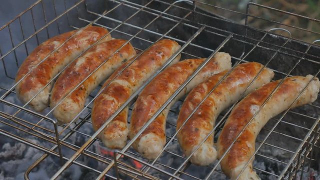 Grill grille and barbecue and mangala mesh. Preparation of sausage on a fire