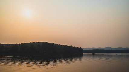 Naklejka premium West Lake landscape with reflections in water at sunset, Hangzhou, China