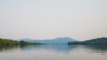 West Lake landscape with reflections in water at sunset, Hangzhou, China