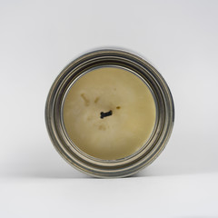 Unlit craft candle in a metal can. 