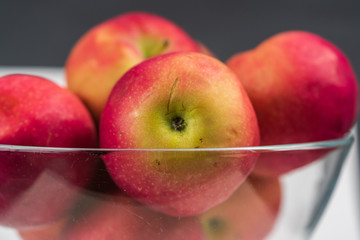 Apples in a clear glass bowl. 