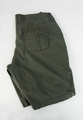 Pair of olive green shorts isolated on light background