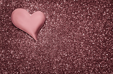 Satin dusty rose colour heart on a glittering background