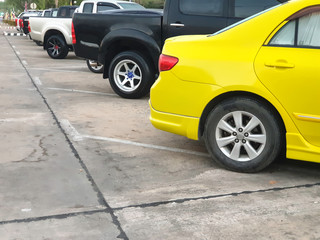 Car parked neatly inside an outdoor parking lot.