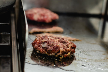 Some patties of ground meat with bacon