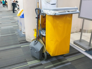 Janitorial car and mop bucket on cleaning in process.