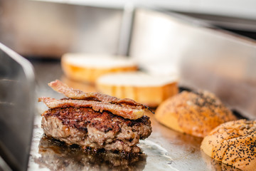 Some patties of ground meat with bacon