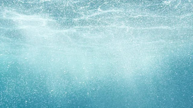 Underwater view of a girl falling into the sea