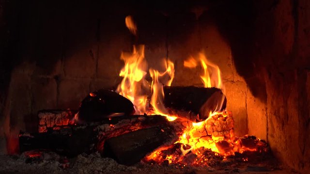 Wood burning in a cozy fireplace at home, keep warm. texture