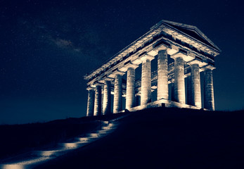 Roman monument and steps lit up at night with the stars in the sky at Penshaw 