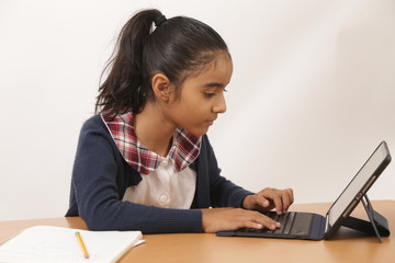 brunette latin student with school uniform in various poses, bored, smiling, thoughtful, studying, concentrated, using ipad and writing