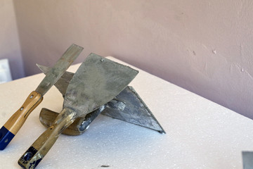 Craftsman plaster tools. Trowel, putty scraper, polished trowel.