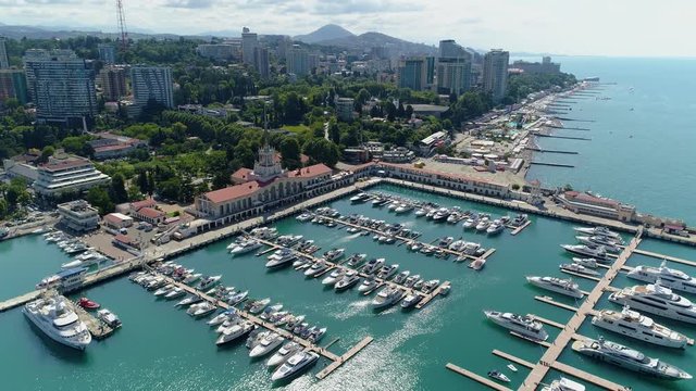 General plan beautiful cityscape Sochi Russia famous resort. Unique maritime center city promenade, beaches azure sea, hotels, modern yachts piers. Summer journey freedom horizon clouds. Aerial drone