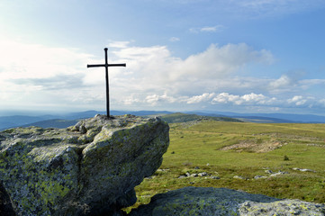 A magnificent viewpoint panoramic at the top of a mountain with a religious cross. Saint Jacques de Compostelle pilgrimage