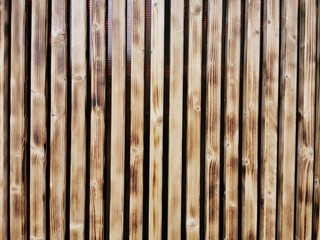 Wooden thin slats with traces of firing. Thin vertical slats.Wooden background.