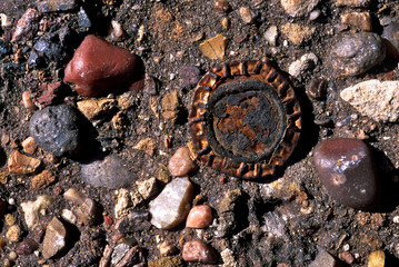 Closeup of abandoned old Route 66 road surface and bottlecap near Navajo, Arizona