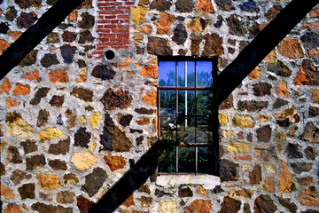 Fototapete Route 66 Shadow of roof beams and rock wall of old gas station from the heyday of Old Route 66, Narcissa, Oklahoma  © John Nakata