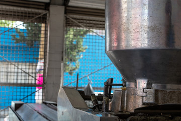 man selling dough in nixtamal millfrontal view of a tortillas machine