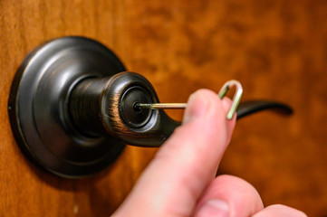 Obraz na płótnie Canvas Oiled brass interior bedroom door handle with unlocking pin