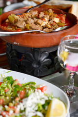 Traditional Turkish lunch of Tandir Guvec stew after removing bread top from clay pot