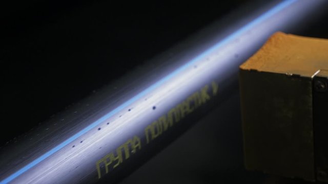 Laser Marking Machine Engraving Powder Paint. Manufacture of plastic water pipes of the factory. Process of making plastic tubes on the machine tool with the use of water and air pressure.
