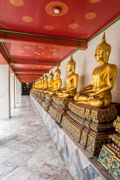 Bangkok, Thailand diagonal row of gold buddha statues