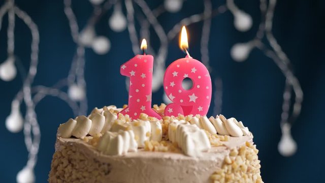 Birthday cake with 19 number pink candle on blue backgraund. Candles blow out. Slow motion and close-up view