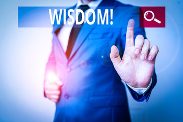 Conceptual hand writing showing Wisdom. Concept meaning quality having experience knowledge and good judgement something Businessman with pointing finger in front of him