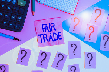 Handwriting text Fair Trade. Conceptual photo buying goods directly from producers in developing countries Mathematics stuff and writing equipment above pastel colours background