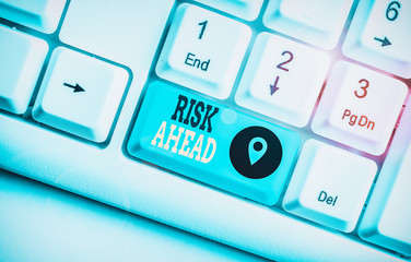 Conceptual hand writing showing Risk Ahead. Concept meaning A probability or threat of damage, injury, liability, loss White pc keyboard with note paper above the white background