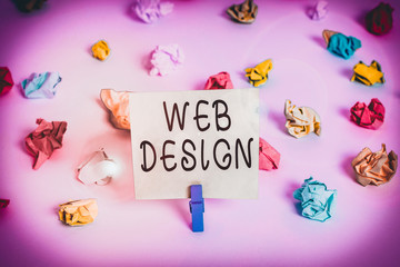 Word writing text Web Design. Business photo showcasing Website development Designing and process of creating websites Colored crumpled papers empty reminder white floor background clothespin