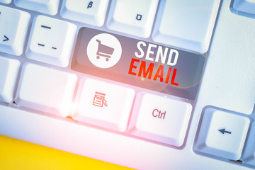Conceptual hand writing showing Send Email. Concept meaning the system for using computers to send messages over the internet White pc keyboard with note paper above the white background