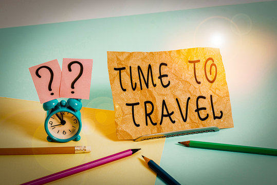 Conceptual hand writing showing Time To Travel. Concept meaning Moving or going from one place to another on vacation Mini size alarm clock beside stationary on pastel backdrop