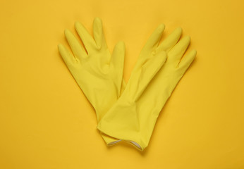 Latex gloves for cleaning on a yellow background. The concept of cleaning. Studio shot. Top view
