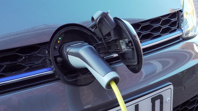 Electric car is plugged into home charging point