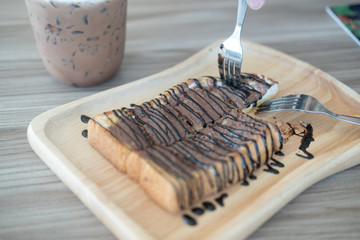 Sliced toasted bread topping with chocolate sauce