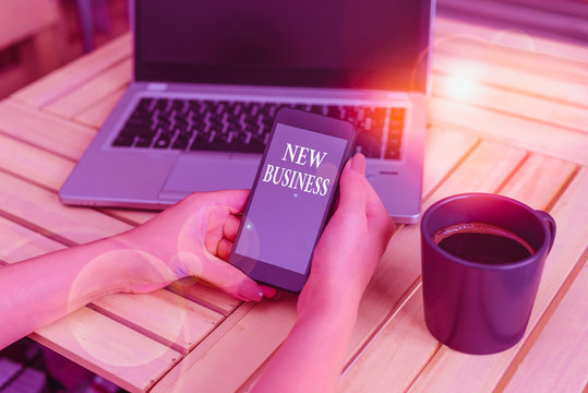 Writing note showing New Business. Business concept for the activity of buying and selling goods and services woman with laptop smartphone and office supplies technology