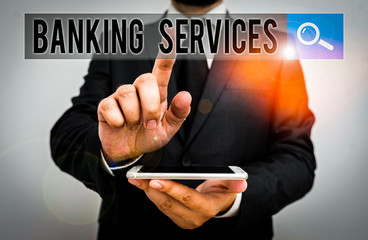 Writing note showing Banking Services. Business concept for tools for analysisaging demonstratingal finances and building assets Male human wear formal work suit hold smartphone using hand