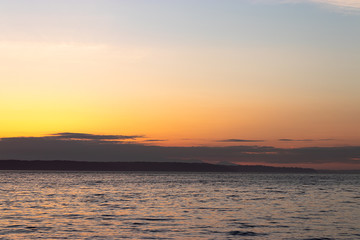 bright blue water of puget sound along shoreline of washington