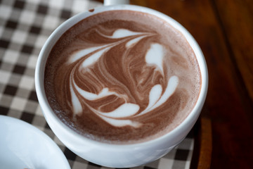 Hot chocolate latte art in white cup