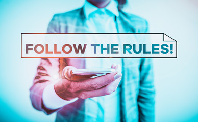 Handwriting text Follow The Rules. Conceptual photo go with regulations governing conduct or procedure Business concept with mobile phone and business woman