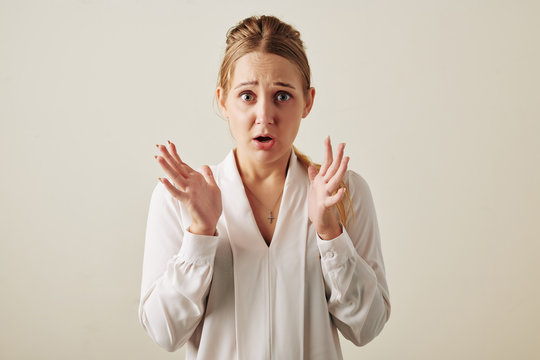 Portrait of scared emotional young woman looking at camera