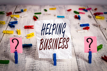 Handwriting text Helping Business. Conceptual photo improving some measure of an enterprise s is success Scribbled and crumbling sheet with paper clips placed on the wooden table