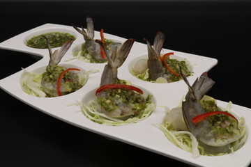 Thai raw shrimp salad with seafood sauce in white plate