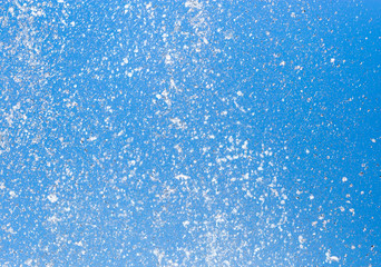Splashing water from a fountain on a background of blue sky