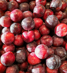 Ripe plum in the store as a background