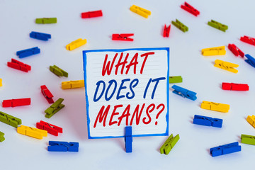 Handwriting text What Does It Means Question. Conceptual photo asking meaning something said and do not understand Colored clothespin papers empty reminder white floor background office