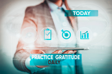 Conceptual hand writing showing Practice Gratitude Daily. Concept meaning be grateful to those who helped encouarged you Female human wear formal work suit presenting smart device